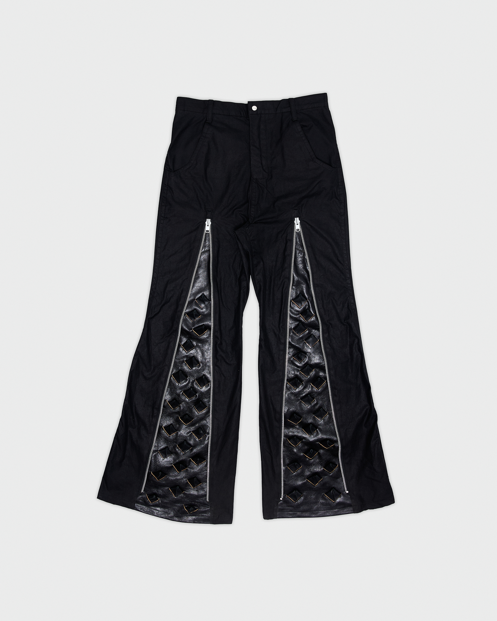 - Slim fit with bootcut leg<br />- Front feature an elogated zipper that reveals a croco 3-D leather panel