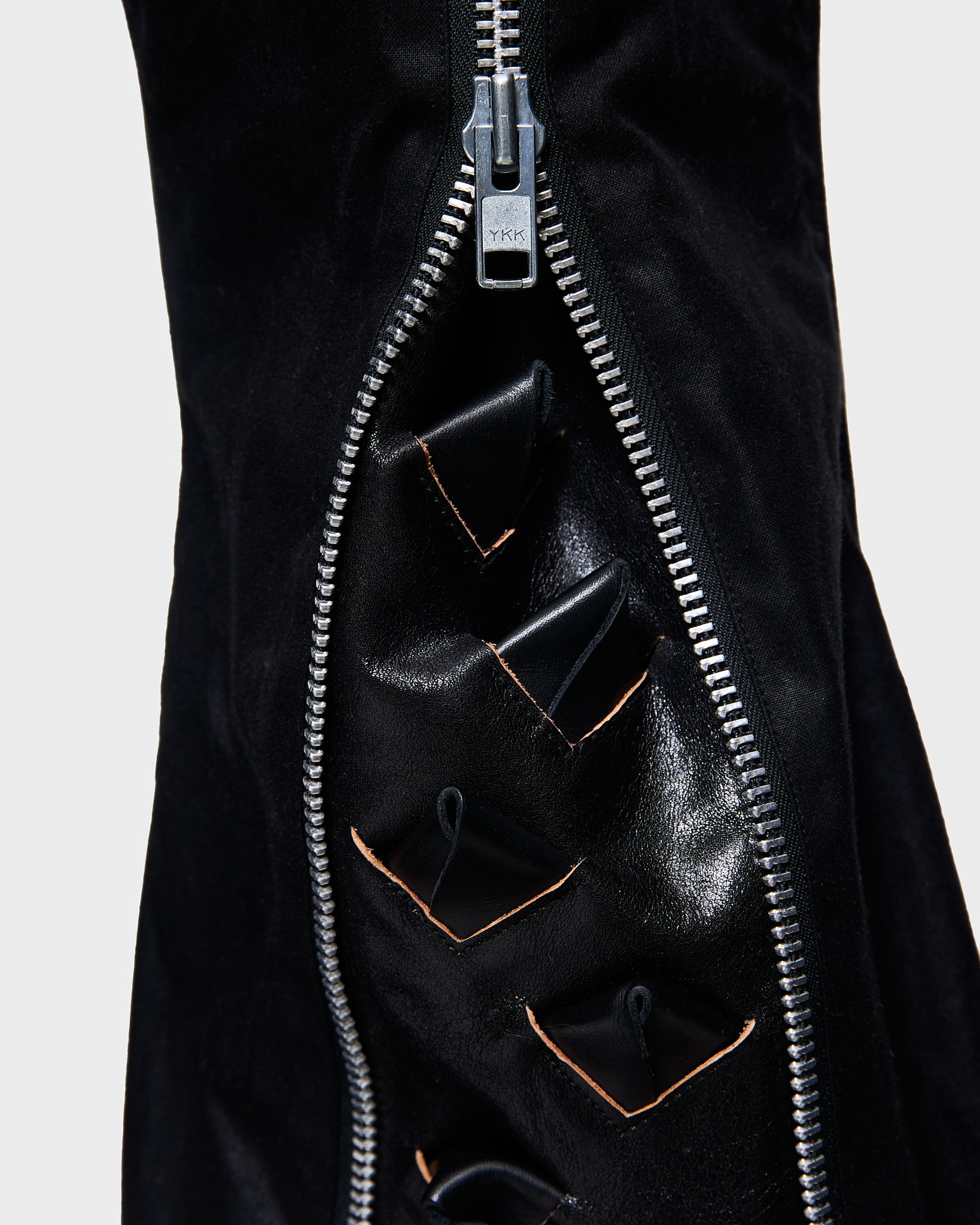 - Slim fit with bootcut leg<br />- Front feature an elogated zipper that reveals a croco 3-D leather panel