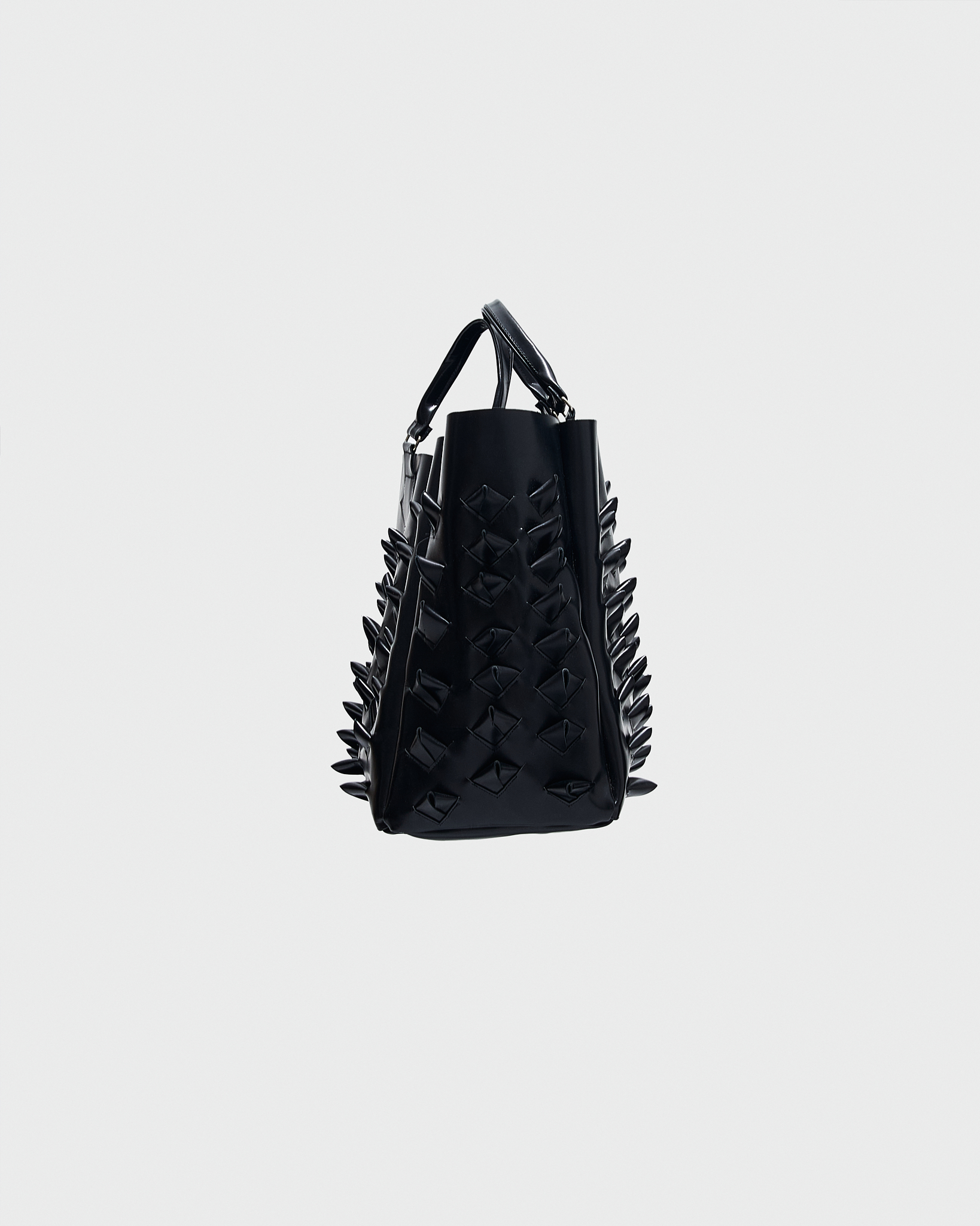 - Tote bag<br />- Croco 3-D leather spikes all over the bag<br />- Leather handles